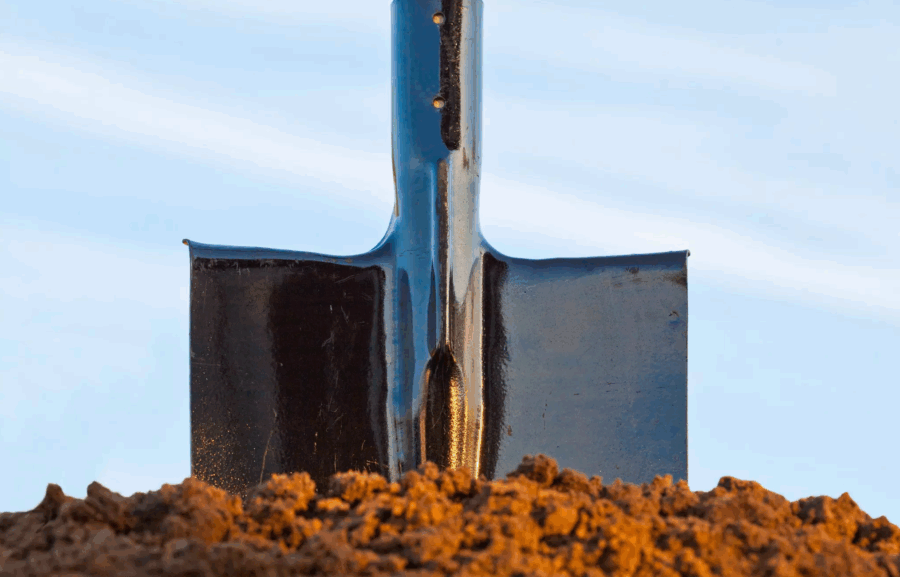 Shovel digging into dirt