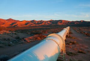 gas gathering pipelines desert mountains at sunset